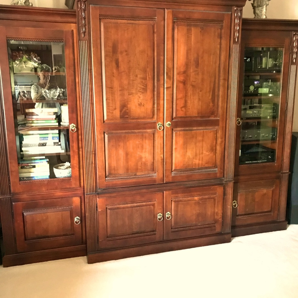 Solid wood 3 section entertainment center.  Could be mirrored and used as a bar.